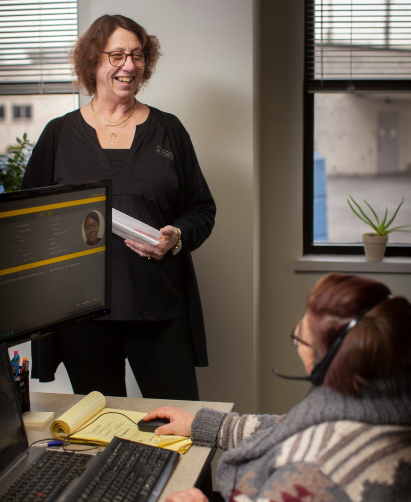 Melissa Stark, talking with employee