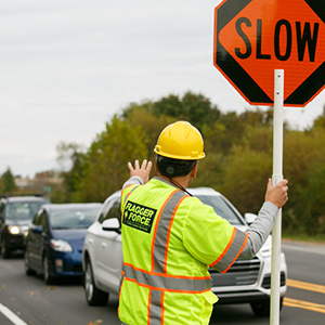 Flagger Force employee stops vehicle in work zone