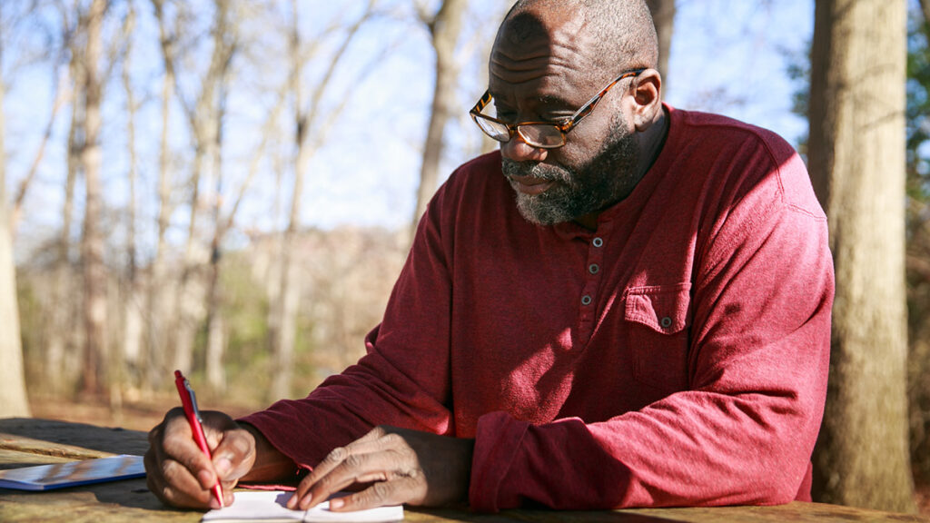 photo of Robert writing outside