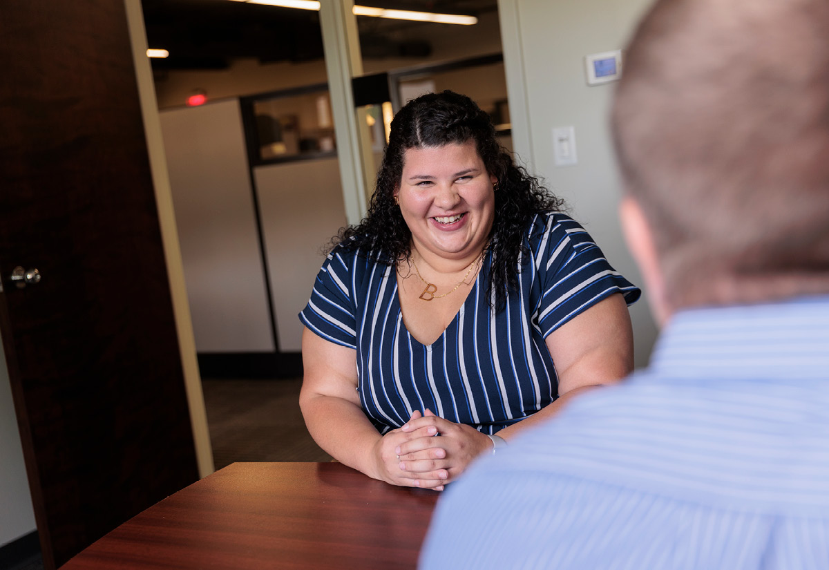 Brittani Priester, employee spotlight, smiling in meeting