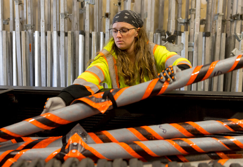 Employee Spotlight : Kristin loading sign in bed of truck