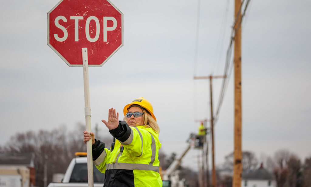 Flagger Force female flagger in work zone with traffic stopped