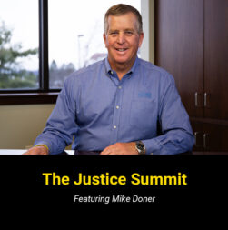 Mike Doner sitting at his desk with the text overlay "The Justice Summit".